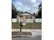 Small one story home with boarded up windows and door and white fence surrounding the lot at 1905 S Westmoreland Dr, Orlando, FL 32805
