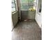 Enclosed sunroom featuring wood-look floors, large windows, and a painted block accent wall, ready for customization at 1905 S Westmoreland Dr, Orlando, FL 32805