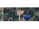 Aerial view showing the location of the lot with a beautiful lake nearby at 2132 Pine Meadows Golf Course Rd, Eustis, FL 32726