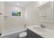 Bright bathroom featuring gray vanity, quartz countertop, tiled shower and tub at 2132 Pine Meadows Golf Course Rd, Eustis, FL 32726