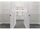 En suite bathroom featuring dual vanities, modern lighting, and spacious walk-in closets on either side at 2132 Pine Meadows Golf Course Rd, Eustis, FL 32726
