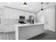 Kitchen featuring white cabinets, stainless steel appliances, and island with quartz countertops at 2132 Pine Meadows Golf Course Rd, Eustis, FL 32726