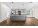 A kitchen featuring gray cabinets, stainless steel appliances, and a large island with a quartz countertop at 2132 Pine Meadows Golf Course Rd, Eustis, FL 32726