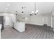 Open-concept living area featuring kitchen with an island, ceiling fans and modern lighting at 2132 Pine Meadows Golf Course Rd, Eustis, FL 32726
