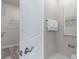 Bright bathroom with a towel rack, stylish decor, and access to a walk-in closet with wood-look flooring at 2334 Lily Bloom Rd, St Cloud, FL 34771