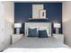Stylishly furnished bedroom with a padded headboard, decorative pillows, and accent lighting creates a relaxing ambiance at 2334 Lily Bloom Rd, St Cloud, FL 34771