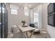 Flex room with stylish decor, including a table, seating, and natural light from two windows at 2334 Lily Bloom Rd, St Cloud, FL 34771