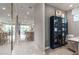 Hallway with tile floors and a view of the kitchen and living area with a built-in cabinet at 2334 Lily Bloom Rd, St Cloud, FL 34771