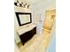 Well-lit bathroom featuring dark wood vanity, modern mirror, and tiled shower at 238 Riverbend Dr # 105, Altamonte Springs, FL 32714