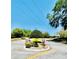 Entrance to community features lush landscaping with palm trees and beautiful hedges at 238 Riverbend Dr # 105, Altamonte Springs, FL 32714