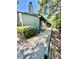 Exterior view of the home featuring a walkway, gray siding, and a chimney at 238 Riverbend Dr # 105, Altamonte Springs, FL 32714