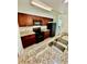 Kitchen features granite countertops, a stainless steel sink, black appliances, and dark wood cabinets at 238 Riverbend Dr # 105, Altamonte Springs, FL 32714