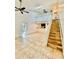 Open-concept living room featuring tiled floors, high ceilings, a skylight, and stairs to the second floor at 238 Riverbend Dr # 105, Altamonte Springs, FL 32714