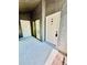 View of the patio featuring a door with unit E, gray textured walls, and tile flooring at 238 Riverbend Dr # 105, Altamonte Springs, FL 32714