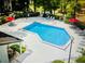 Large community pool with lounge chairs, picnic tables, and umbrellas at 238 Riverbend Dr # 105, Altamonte Springs, FL 32714