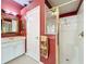 Bathroom featuring a shower, vanity with sink, and white door at 2409 Twickingham Ct, Clermont, FL 34711