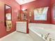 Bathroom featuring a soaking tub and a vanity with ample counter space at 2409 Twickingham Ct, Clermont, FL 34711