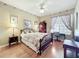 Bedroom with floral wallpaper, ceiling fan, and desk by the window at 2409 Twickingham Ct, Clermont, FL 34711