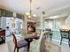 Bright breakfast nook with a chandelier over a glass table and chairs, offering a sunny spot to enjoy meals at 2409 Twickingham Ct, Clermont, FL 34711