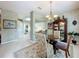 Cozy breakfast nook featuring a glass table, decorative rug, and a hutch for displaying glassware and decor at 2409 Twickingham Ct, Clermont, FL 34711