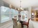 Light-filled dining area featuring a glass table and views to the living area at 2409 Twickingham Ct, Clermont, FL 34711