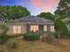 Exterior view featuring solar panels and a screened-in patio, highlighting the home's eco-friendly features and outdoor space at 2409 Twickingham Ct, Clermont, FL 34711