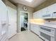 Bright kitchen features white appliances, cabinets, and countertops at 2409 Twickingham Ct, Clermont, FL 34711
