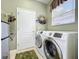 Well-equipped laundry room features a modern washer and dryer set, adding convenience to daily chores at 2409 Twickingham Ct, Clermont, FL 34711