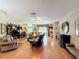 Open-concept living room featuring hardwood floors and a ceiling fan at 2409 Twickingham Ct, Clermont, FL 34711