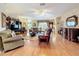 Bright living room with hardwood floors, large TV, and comfortable seating arrangements at 2409 Twickingham Ct, Clermont, FL 34711