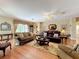 Spacious living room featuring hardwood floors, elegant furnishings, and decorative accents at 2409 Twickingham Ct, Clermont, FL 34711