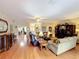Spacious living area with hardwood floors, ceiling fan, and open layout at 2409 Twickingham Ct, Clermont, FL 34711