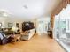 Open living room with hardwood floors connecting to the outdoor patio at 2409 Twickingham Ct, Clermont, FL 34711