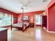 Spacious main bedroom boasts hardwood floors, a four-poster bed, and elegant decor at 2409 Twickingham Ct, Clermont, FL 34711