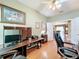Well-lit office space with wood furnishings and connection to the living room at 2409 Twickingham Ct, Clermont, FL 34711
