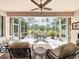 Relax in this screened-in patio with a ceiling fan and a scenic view of the surrounding trees at 2409 Twickingham Ct, Clermont, FL 34711