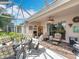 Inviting screened-in patio with cozy seating arrangements, creating a perfect spot for relaxation and entertainment at 2409 Twickingham Ct, Clermont, FL 34711