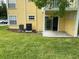 Yellow apartment building with a patio and well-maintained green lawn at 2442 Sweetwater Club Cir # 43, Kissimmee, FL 34746