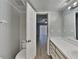 Bathroom with white fixtures, tile floors, and a view into the bedroom at 2442 Sweetwater Club Cir # 43, Kissimmee, FL 34746