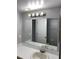 Bathroom featuring a white countertop sink, light fixture, and large mirror at 2442 Sweetwater Club Cir # 43, Kissimmee, FL 34746
