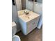 Bathroom sink vanity with white countertop and a wood laminate floor at 2442 Sweetwater Club Cir # 43, Kissimmee, FL 34746