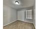 Bedroom featuring light grey walls, wood laminate floors, and a double door closet at 2442 Sweetwater Club Cir # 43, Kissimmee, FL 34746