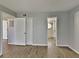 Clean bedroom with wood-look floors, closet and open bathroom entrance at 2442 Sweetwater Club Cir # 43, Kissimmee, FL 34746