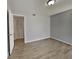 Bedroom featuring light grey walls, laminate wood floors, and double door closet at 2442 Sweetwater Club Cir # 43, Kissimmee, FL 34746