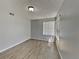 Bedroom featuring light grey walls, laminate wood floors, and window at 2442 Sweetwater Club Cir # 43, Kissimmee, FL 34746