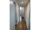 Hallway featuring tile flooring, closet doors, and a view to a shower at 2442 Sweetwater Club Cir # 43, Kissimmee, FL 34746