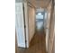 Bright hallway featuring wood-look tile flooring, white doors, and access to the living area at 2442 Sweetwater Club Cir # 43, Kissimmee, FL 34746