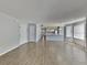 Open living space with wood-look flooring, white walls, and a view into the kitchen at 2442 Sweetwater Club Cir # 43, Kissimmee, FL 34746