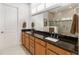 Bathroom features double sinks with granite countertops and a walk-in shower at 2789 Southland St, St Cloud, FL 34772