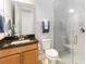 Bathroom with modern vanity, toilet, and shower with sleek glass door at 2789 Southland St, St Cloud, FL 34772